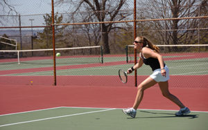 Student playing tennis